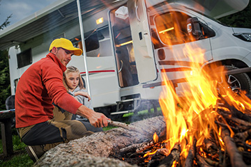 father and daughter by the campfire